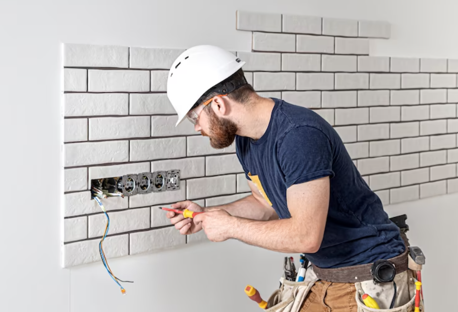 A professional service team member completing skilled electrical work